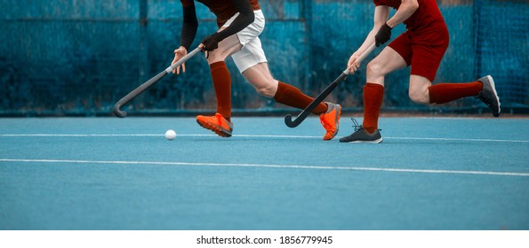 Two man battle for control of ball during field hockey game. Sport team concept. Vintage color filter - Powered by Shutterstock