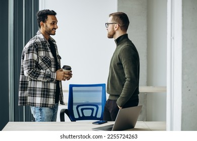 Two man colleagues working together at the office - Shutterstock ID 2255724263