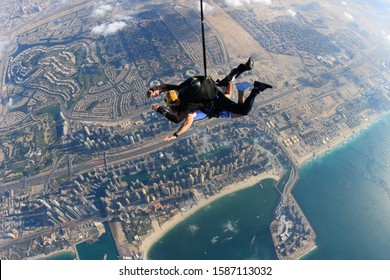 Two man are doing a sky diving in Dubai. Tandem in the sky.