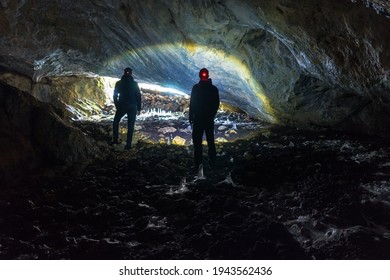 Two man exploring dark cave with light headlamp underground. Cave Ledenjaca in Bosnia and Herzegovina.
