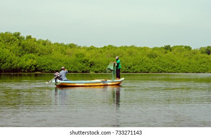 Two Man Fishing On A Boat With Net In The Estuary Of Rural Fishery Community Called La Lupe In Chiapas Mexico