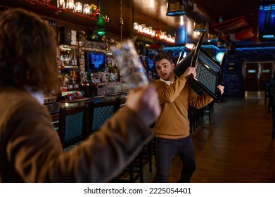 Two man hooligan football fans get in bar fight
