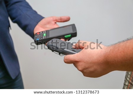 Two Man Sharing  Handheld Mobile Computers Data