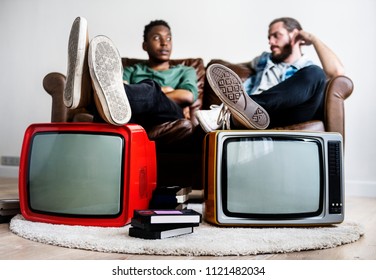 Two Man Sitting And Two Retro Television