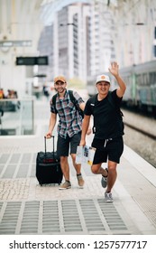 Two Man Traveler Miss Train And Running After Train On Platform On Railway Station.