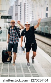 Two Man Traveler Miss Train And Running After Train On Platform On Railway Station.