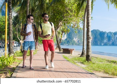 Two Man Using Cell Smart Phones Tropical Park Couple Chatting Online Holiday Sea Summer Vacation Ocean Travel - Powered by Shutterstock