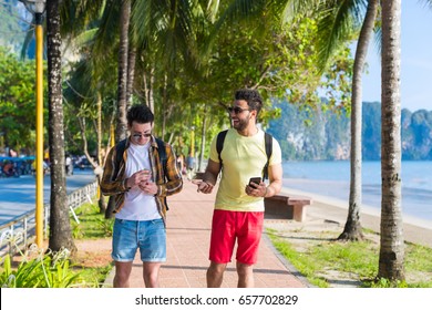 Two Man Using Cell Smart Phones Tropical Park Couple Chatting Online Holiday Sea Summer Vacation Ocean Travel - Powered by Shutterstock