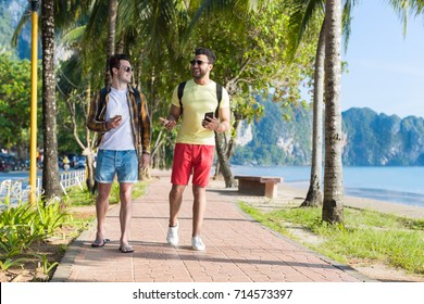 Two Man Using Cell Smart Phones Tropical Park Couple Chatting Online Holiday Sea Summer Vacation Ocean Travel - Powered by Shutterstock