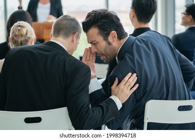 two man whispering while sitting in audience at conference room - Powered by Shutterstock