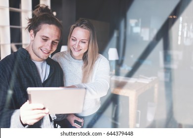 Two Managers Discussing Profit. Group Of Business People Working Together In Loft Office. Young Startup. Windows Reflection Effect