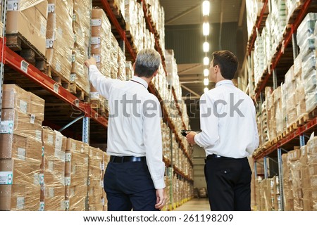 two managers workers in warehouse with bar code scanner