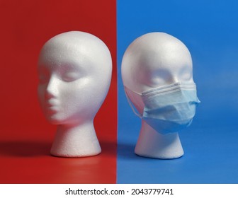 Two mannequin head's are divided on political party lines. One is wearing a face mask while the other is not for a message about the mask debate and covid.