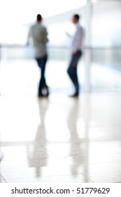 Two Mans Silhouette In Hall Of Office Building