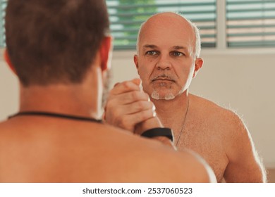 Two martial artists are practicing a move together in a bright training room. One is older and more experienced, potentially a coach or teacher, and the other is younger, likely his student - Powered by Shutterstock