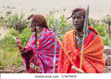 Two Masai Warriors Standing And Looking Away
