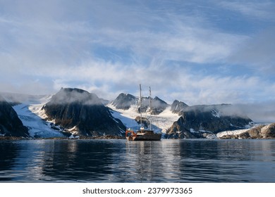 Two masted sailing ship on a summer adventure in Hamilton Bay, Rand Fjord, Svalbard, Arctic
