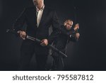 two mature modern samurai with katanas isolated on black