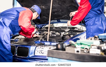 Two Mechanics Working On A Car