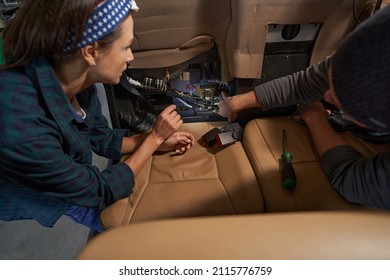 Two Mechanics Working Together In Salon Of Airplane While Inspecting System