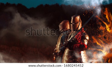 Two Medieval knights armed with axe and sword.