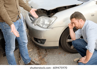 Two Men Arguing After A Car Accident On The Road