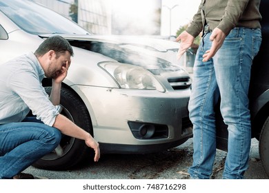 Two Men Arguing After A Car Accident On The Road