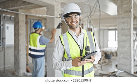 Two men builders smiling confident using touchpad at construction site - Powered by Shutterstock