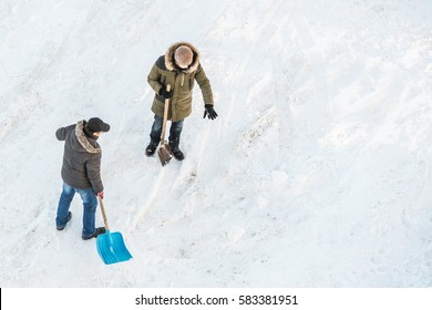 Two Men Cleans Snow Shovel, Top View