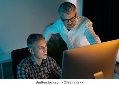 Two Men Collaborating On A Project In An Office, Showing Teamwork And Professionalism