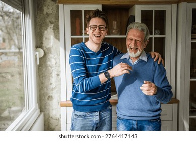 Two men of different generations connecting and smiling, sharing a heartfelt conversation while standing together, demonstrating family support and inter generational relationships at home