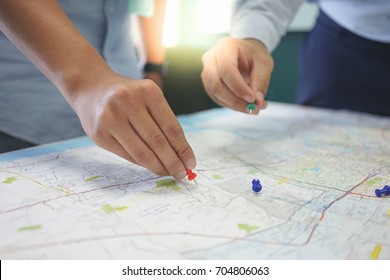 Two Men Are Discussing Their Business Topic About The Customer Target Area On The Map. They Are Pinning The Pin On The Map.