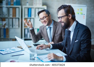 Two Men Discussion Presentation On Laptop