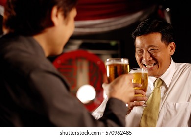 Two Men Drinking Beer Together