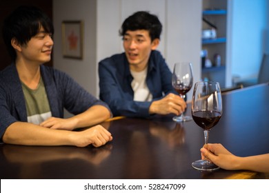 Two Men Drinking Wine While Talking