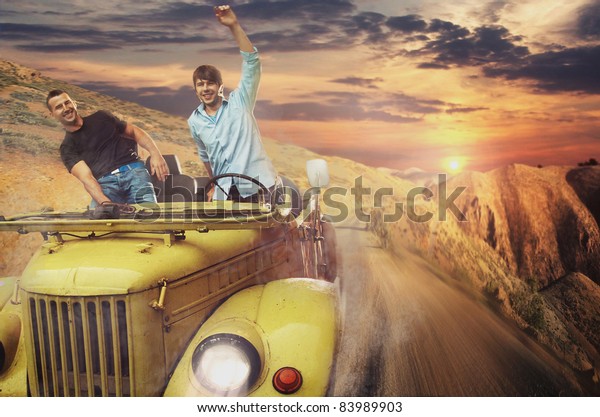 Two men driving a\
car