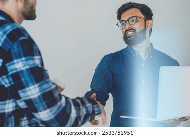 Two of men is engaging in a professional handshake with a Caucasian man, showcasing a friendly business interaction. Two of colleagues handshaking for corporate business teamwork - Powered by Shutterstock