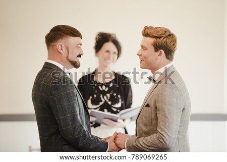 Two men are exchanging vows on their wedding day.