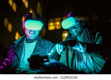 two men explore metaverse via headsets and augmented reality, using a technological device as a compass for NFT object research, neon light effect, cityscape background