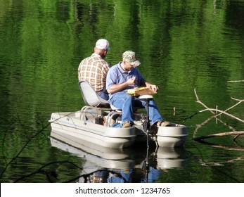 Two Men Fishing In A Boat