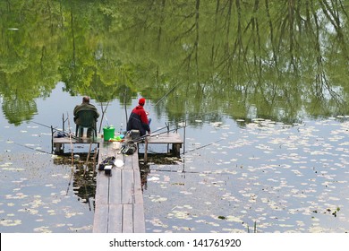 Two Men Fishing On The Lake