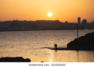 Two Men Fishing On Sunset