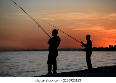 Two Men Fishing In The Sunset 