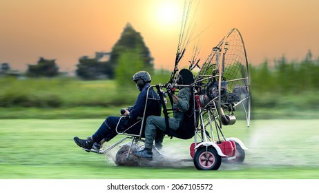 Two men flying and gliding in the air, Flying on paramotor, Preparation for flights on paramotors, Tandem paramotorgliding.