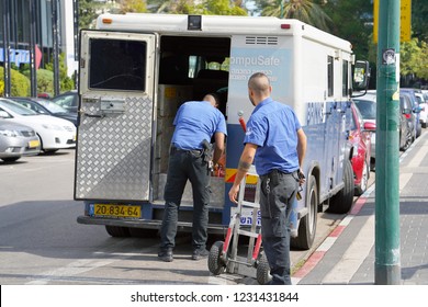 Two Men Of The Guards Of The Truck Of Brink's Company Put The Money Bags In The Car. Guards Transporting Money. Guards With Guns Transporting Money. 11 November 2018. Tel Aviv. Israel.