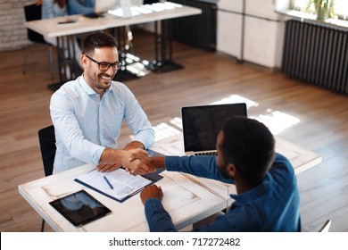 Two Men Handshake In The Office