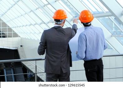 Two men in hard hats at construction site