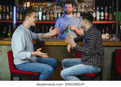 Two men is having fun chatting with a bartender in bar counter while drinking in a pub. - Powered by Shutterstock