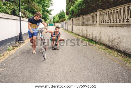 Similar – Image, Stock Photo Two men having fun riding bike and skateboard