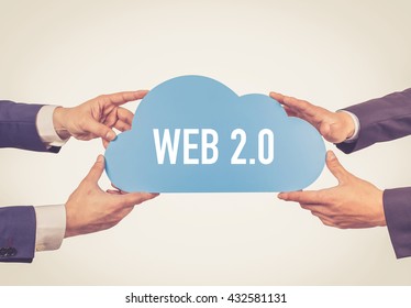 Two men holding cloud with Web 2.0 text